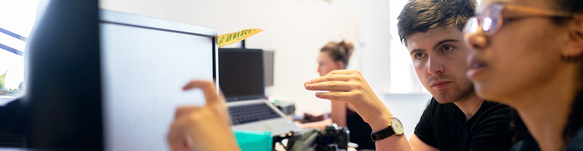 two-people-at-computer-coding